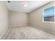 Bright bedroom featuring carpeted floors, light walls, and a window at 15547 Hamlin Blossom Ave, Winter Garden, FL 34787