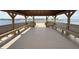 Covered dock interior featuring built-in seating and a view of the surrounding lake at 15547 Hamlin Blossom Ave, Winter Garden, FL 34787