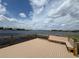 Scenic lake view from dock featuring built-in bench seating and wood railing at 15547 Hamlin Blossom Ave, Winter Garden, FL 34787