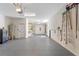 Spacious garage with a water heater, shelving and plenty of room for storage and vehicles at 15547 Hamlin Blossom Ave, Winter Garden, FL 34787