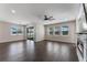 Spacious living room featuring a modern fireplace, ceiling fan, and sliding doors to the patio at 15547 Hamlin Blossom Ave, Winter Garden, FL 34787