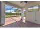 Covered patio with brick flooring, ceiling fan and outdoor TV at 15547 Hamlin Blossom Ave, Winter Garden, FL 34787
