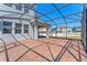 Screened-in patio with brick flooring, offering a great view of the backyard at 15547 Hamlin Blossom Ave, Winter Garden, FL 34787