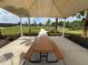 Shaded picnic table with seating offers a relaxing outdoor dining area with manicured landscaping at 15547 Hamlin Blossom Ave, Winter Garden, FL 34787