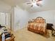 A functional bedroom with a fan and ample space but some clutter at 1614 Stanbury Dr, Orlando, FL 32818