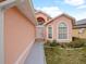 Charming home exterior showcasing its welcoming facade, well-manicured lawn, and inviting entrance at 1614 Stanbury Dr, Orlando, FL 32818