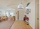 Inviting foyer with tile flooring and entry to the living room, complete with charming decor and natural light at 1614 Stanbury Dr, Orlando, FL 32818