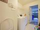 Efficient laundry room featuring a washing machine and access to the garage at 1614 Stanbury Dr, Orlando, FL 32818