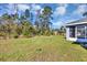 Expansive backyard with lush green grass and mature trees offers ample space for recreation and relaxation at 17008 Sw 32Nd Ter, Ocala, FL 34473
