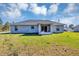 The backyard features a screened lanai and plenty of green space, ideal for outdoor activities and entertaining at 17008 Sw 32Nd Ter, Ocala, FL 34473