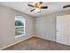 Carpeted bedroom with ceiling fan and natural light from the window at 17008 Sw 32Nd Ter, Ocala, FL 34473