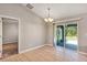 Dining area features tile floors and a chandelier and access to the patio with sliding glass doors at 17008 Sw 32Nd Ter, Ocala, FL 34473