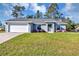 Charming single-story home featuring a well-manicured lawn and an attached two-car garage at 17008 Sw 32Nd Ter, Ocala, FL 34473