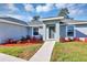 Up close exterior of the home, featuring small landscaping around the front windows and front door at 17008 Sw 32Nd Ter, Ocala, FL 34473
