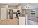 Modern kitchen featuring stainless steel appliances, granite countertops, an eat-in bar and white cabinets at 17008 Sw 32Nd Ter, Ocala, FL 34473