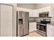 Modern kitchen featuring stainless steel appliances, granite countertops, and white cabinets for a clean and sleek look at 17008 Sw 32Nd Ter, Ocala, FL 34473