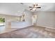 Spacious living room with plush carpet, ceiling fan, and a view into the modern kitchen and dining area at 17008 Sw 32Nd Ter, Ocala, FL 34473