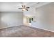 Open-concept living room featuring vaulted ceilings, carpeted floors and light-colored walls at 17008 Sw 32Nd Ter, Ocala, FL 34473
