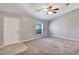 Bright living room features neutral carpet, a ceiling fan, and a large window for ample natural light at 17008 Sw 32Nd Ter, Ocala, FL 34473