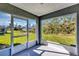 This is a screened lanai with an access door and expansive views of the lush backyard with mature trees at 17008 Sw 32Nd Ter, Ocala, FL 34473