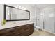 Bathroom with double vanity, large mirror, and walk-in shower at 175 Claffey Ct, Haines City, FL 33844