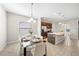Dining area with glass table, white chairs, and modern light fixtures at 175 Claffey Ct, Haines City, FL 33844