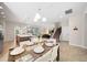 Open concept dining area with glass table and view into the kitchen and living room at 175 Claffey Ct, Haines City, FL 33844