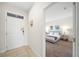 Entryway with white door and view into a bedroom with gray bedding at 175 Claffey Ct, Haines City, FL 33844