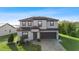 Two-story house with gray siding, brown roof, and a brick paved driveway at 175 Claffey Ct, Haines City, FL 33844