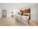 Open concept kitchen features breakfast bar, stainless steel appliances, and tile flooring at 175 Claffey Ct, Haines City, FL 33844