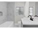 Modern bathroom with marble tile and updated vanity at 204 Louis St, Leesburg, FL 34748