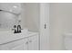 Clean bathroom with white vanity and marble shower at 204 Louis St, Leesburg, FL 34748