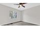 Bright bedroom with ceiling fan and gray flooring at 204 Louis St, Leesburg, FL 34748