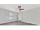 Simple bedroom with gray flooring and a window at 204 Louis St, Leesburg, FL 34748