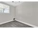 Bright bedroom with large window and grey flooring at 204 Louis St, Leesburg, FL 34748