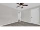 Simple bedroom with gray flooring and ceiling fan at 204 Louis St, Leesburg, FL 34748