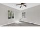 Spacious bedroom with two windows and ceiling fan at 204 Louis St, Leesburg, FL 34748