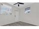 Simple bedroom with two windows and exterior door at 204 Louis St, Leesburg, FL 34748