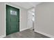 Modern entryway featuring a dark green door and gray flooring at 204 Louis St, Leesburg, FL 34748
