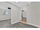 Bright hallway with gray flooring and access to other rooms at 204 Louis St, Leesburg, FL 34748