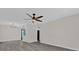 Spacious living room with gray flooring and ceiling fan at 204 Louis St, Leesburg, FL 34748