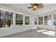 Bright sunroom with windows and wood-look flooring at 204 Louis St, Leesburg, FL 34748