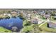 Breathtaking aerial perspective of the home's lakeside setting, showcasing the community and lush landscaping at 2120 Marisol Loop, Kissimmee, FL 34743