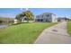 Spacious backyard with a well-maintained lawn and a view of the two-story home at 2120 Marisol Loop, Kissimmee, FL 34743
