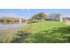 Picturesque backyard featuring a pond and lush green lawn at 2120 Marisol Loop, Kissimmee, FL 34743