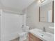 Bathroom features a shower/tub combo and single sink vanity with light wood cabinets at 2120 Marisol Loop, Kissimmee, FL 34743
