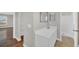 Bright bathroom offers a single sink vanity, a mirror, and a shower at 2120 Marisol Loop, Kissimmee, FL 34743