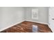 Cozy bedroom featuring wood-look flooring, natural light, and neutral paint at 2120 Marisol Loop, Kissimmee, FL 34743