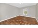 Bright bedroom with natural light features beautiful wood-look flooring and neutral paint at 2120 Marisol Loop, Kissimmee, FL 34743