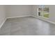 Spacious bedroom featuring tile floors, a large window, and neutral paint colors at 2120 Marisol Loop, Kissimmee, FL 34743